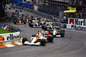MONTE CARLO, MONACO - MAY 12: Ayrton Senna, McLaren MP4-6 Honda, leads Stefano Modena, Tyrrell 020 Honda, and Riccardo Patrese, Williams FW14 Renault, through Sainte Devote at the start during the Monaco GP at Monte Carlo on May 12, 1991 in Monte Carlo, Monaco. (Photo by LAT Images)