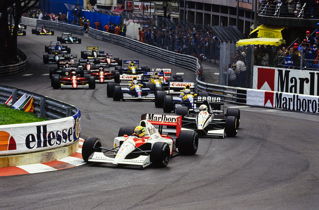 MONTE CARLO, MONACO - MAY 12: Ayrton Senna, McLaren MP4-6 Honda, leads Stefano Modena, Tyrrell 020 Honda, and Riccardo Patrese, Williams FW14 Renault, through Sainte Devote at the start during the Monaco GP at Monte Carlo on May 12, 1991 in Monte Carlo, Monaco. (Photo by LAT Images)